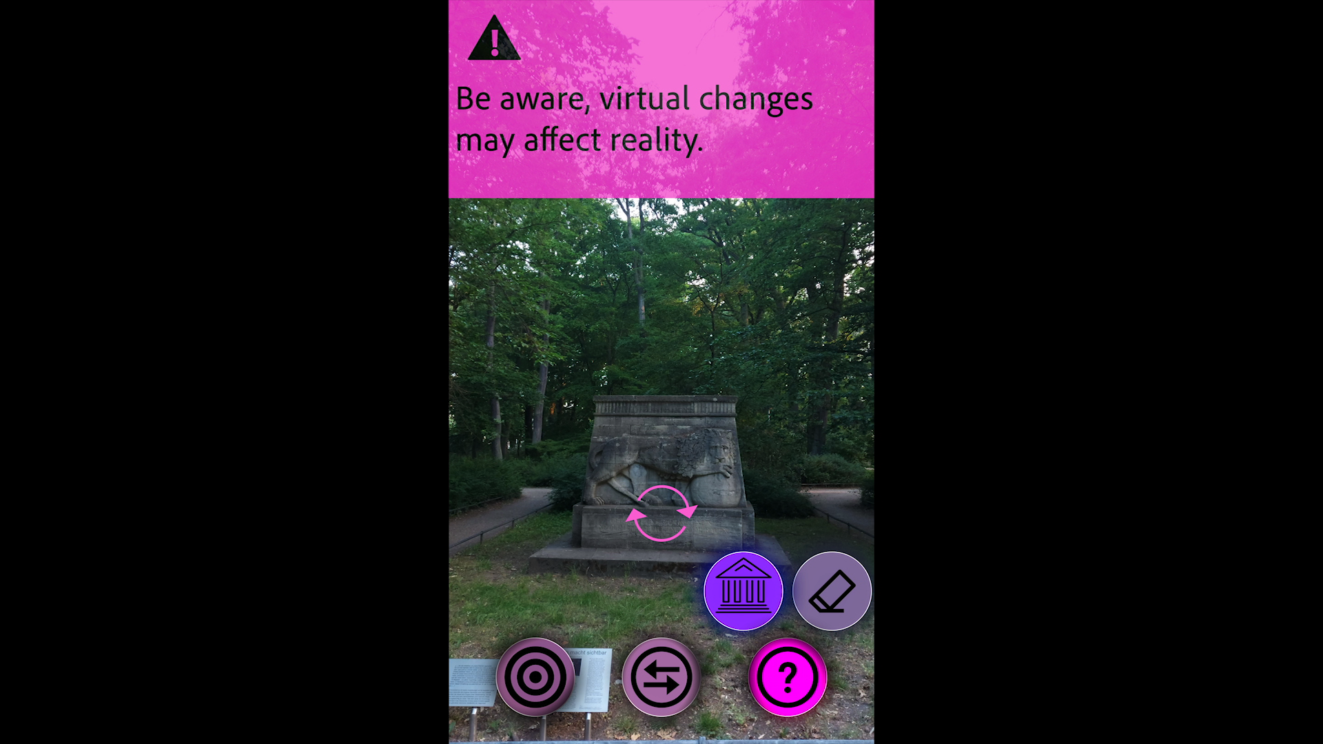 App screen: the warning 'Be aware, virtual changes may affect reality' above a camera view of a stone monument in a park, with round purple app buttons. Testing Trixi (2020) by Nickii Schamborski.