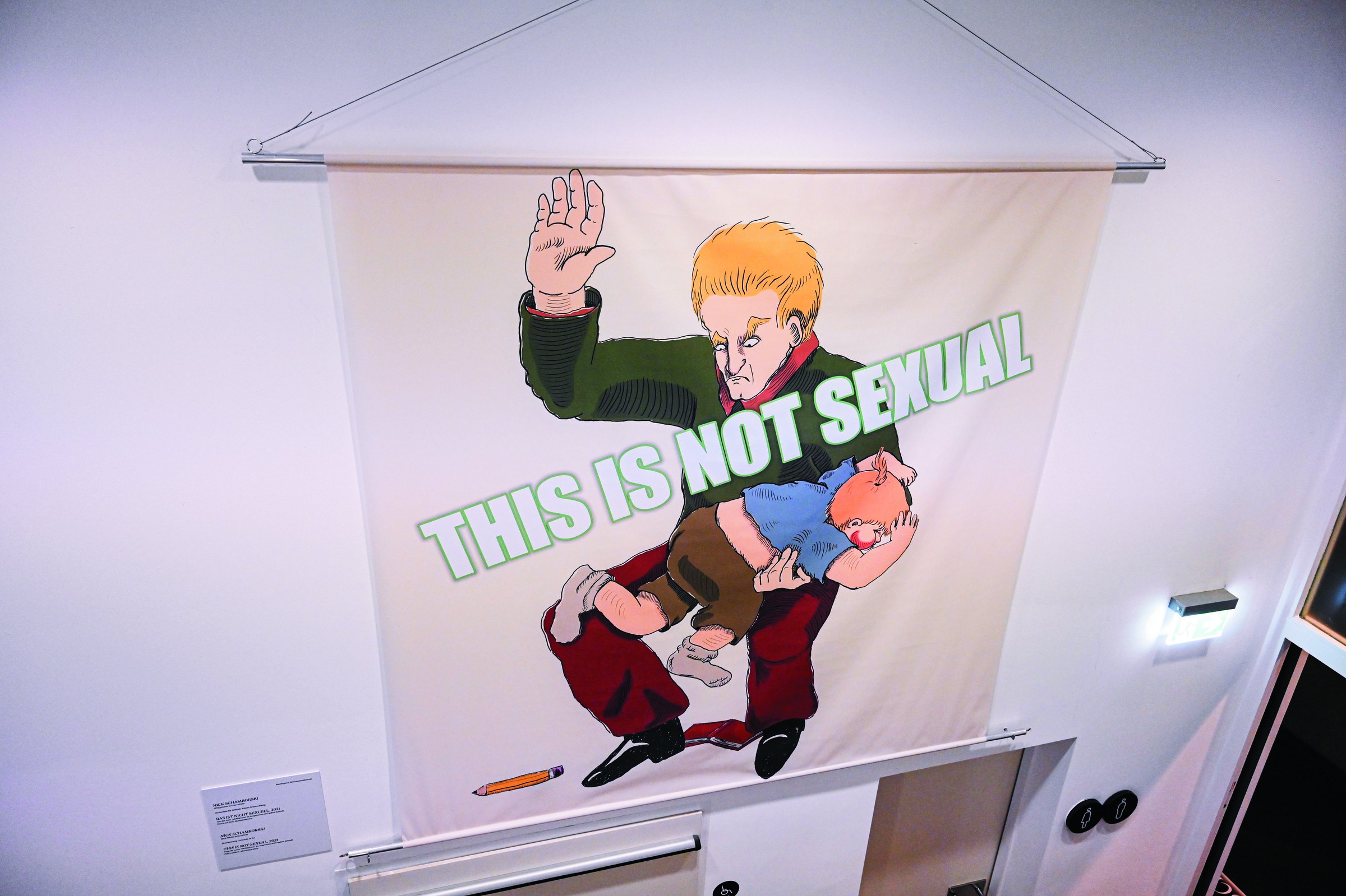 Fabric print: a cartoon adult raises a hand to spank a child lying over his knee; the text across the image reads 'This is not sexual'. MeMärchen (2021) by Nickii Schamborski.