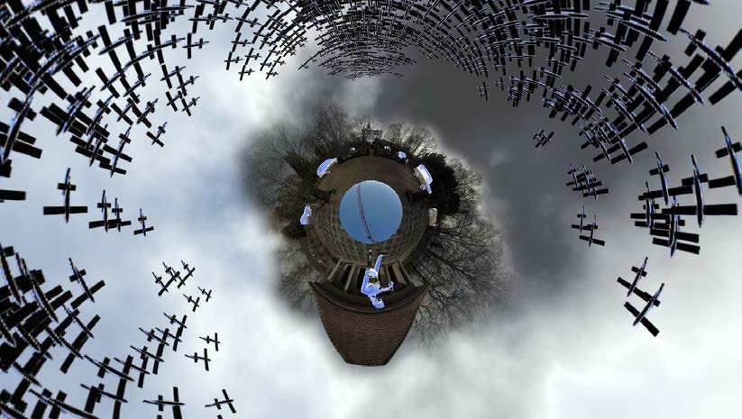 360° image as a 'little planet': a small globe of ground with trees and a castle, surrounded by a sky filled with dark aeroplane silhouettes. Wolfsburg 1933-1945 (2018) by Nickii Schamborski.